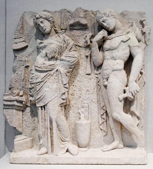 Tarentine funerary relief of a woman and warrior standing near an altar. c315 BC Photo by Marie-Lan Nguyen (2011)  released under Creative Commons Attribution 2.5 Generic